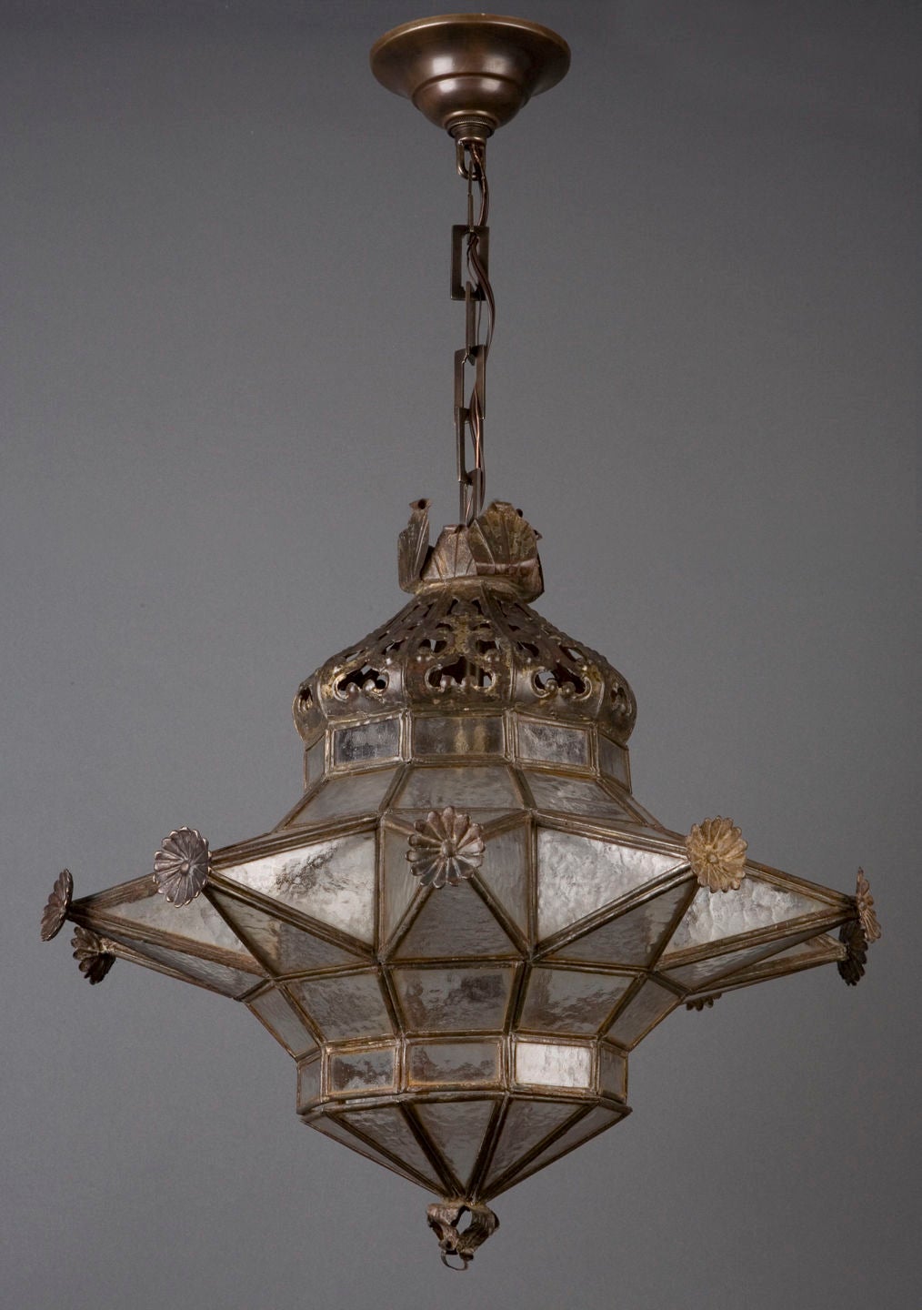 HL3114<br />
A ten-pointed star lantern with pebbled glass panels made of finely beaten darkened iron. From the Jacksonville, Florida estate of Alfred I. DuPont, marked on the reverse with Spanish export stamps. Having two cracks (stabilized) in