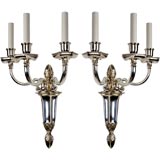 A pair of three arm silver sconces by the E. F. Caldwell Co.