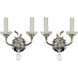 A pair of two arm silver sconces