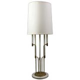 A tall marble and brass table lamp