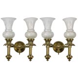 A pair of brass hurricane sconces by E. F. Caldwell