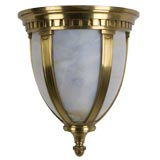 A brass and bent art glass wall sconce