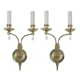 A pair of two arm polished brass sconces
