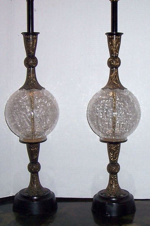 Pair of repousse brass table lamps with crackled glass insets on body. Dark and gold patina.
 Measurements:
Diameter: 6.5