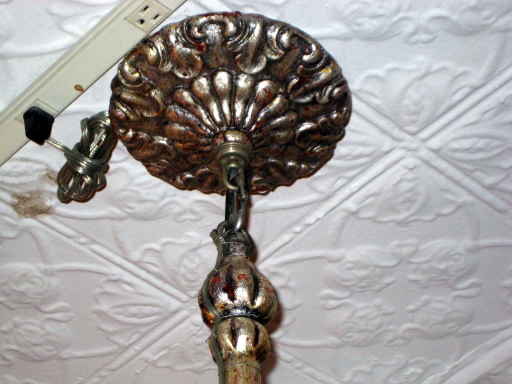 Pair of French carved wood and silver plated eight-light chandeliers, with fluted arms and foliage motif on body.
 