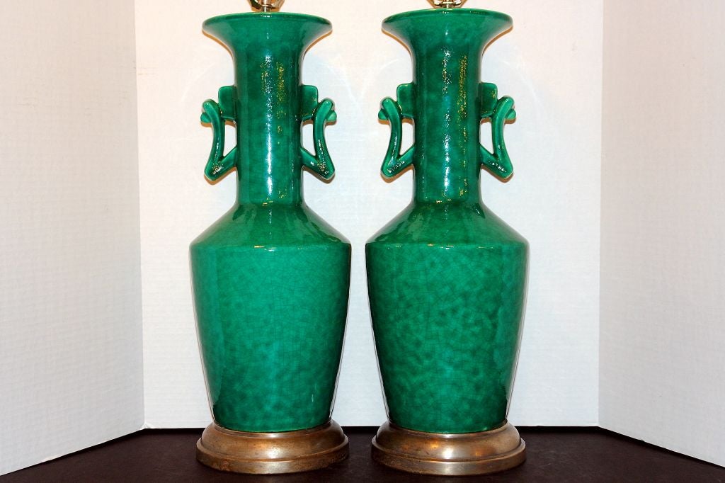 Pair of 1940s French glazed porcelain table lamps with silvered metal base.

Measurements:
Height of body: 22