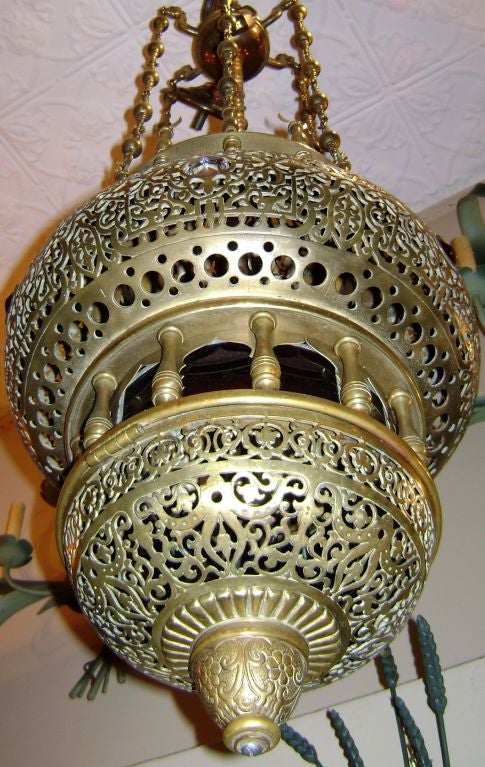 A Turkish pierced bronze lantern with glass insets. 51