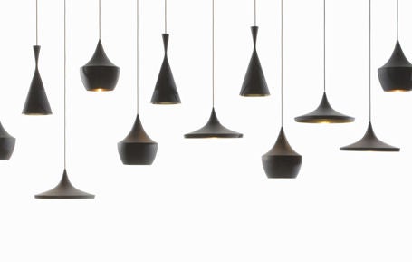 Series of hand-beaten brass pendant lights with black patinated exterior.