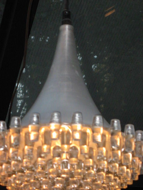 Unusual Raak design with brushed aluminum top and multi tiered crystal bottom. Amazing light source with character.