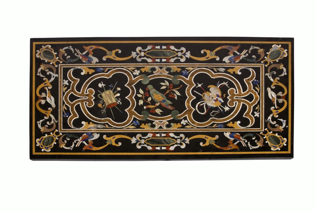 This beautiful inlaid marble table is composed of various multi-colored pieces of marble creating a beautiful Italian renaissance design with a bird on a branch as its centerpiece. The table top is supported by a pair of black slate  block form