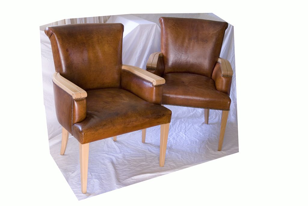 Dark brown leather paired with the clean lines of the light colored wood arms and legs make these chairs a knock-out in a living room, office or hallway. The slight rolled back make them look equally as elegant from a side view.

Note: These