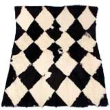 Goat Throw Rug in a Black and Ivory Halrlequin Print