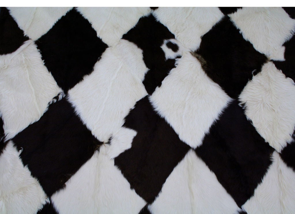 American Goat Throw Rug in a Black and Ivory Halrlequin Print