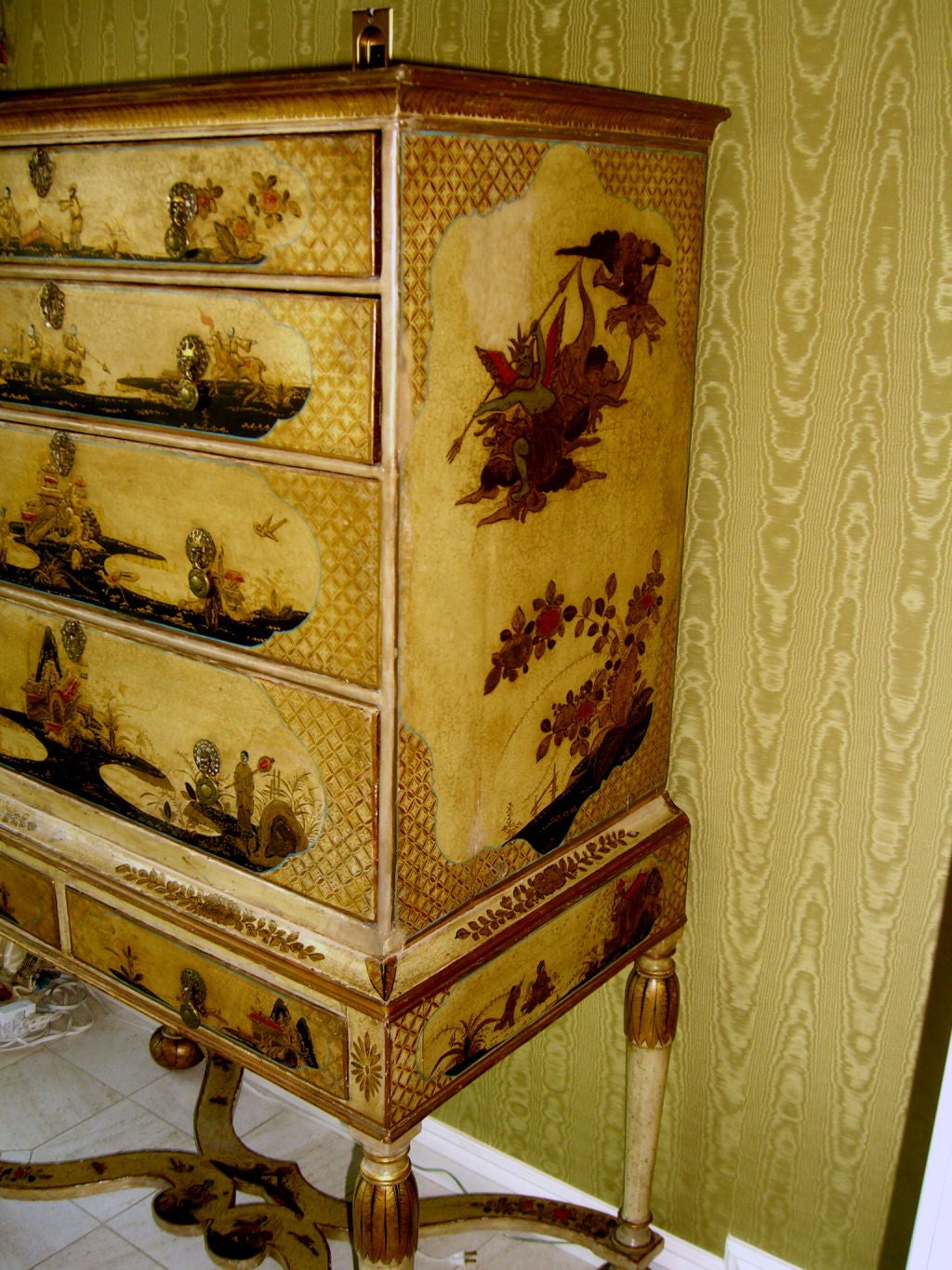A magnificent 18th Century English Chinoiserie chest of drawers on stand. It has a beautiful base color of an ivory or cream color and nice decoration. The drawer interiors have been painted or lined with black paper. There have been repairs to the