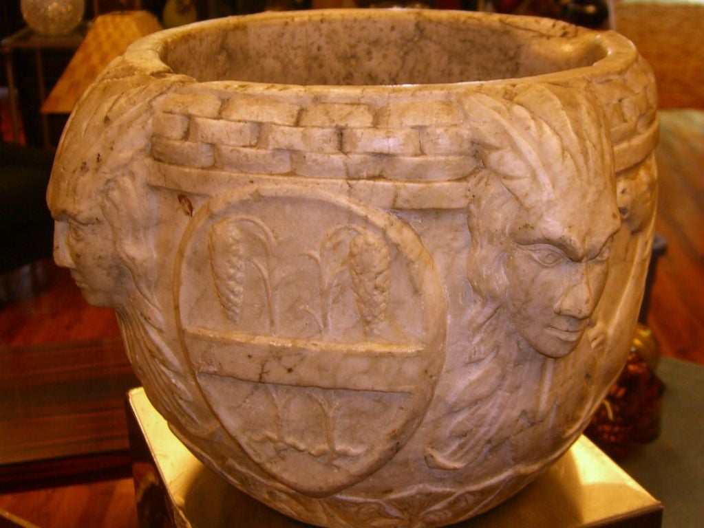 An incredible marble apothecary that dates to the 16th century possibly late 15th century. It depicts a vampire bat on one side, a hippocamp on the other side and a wheat sheaf on the third. The bat is related to the Bacardi and Valencia families as