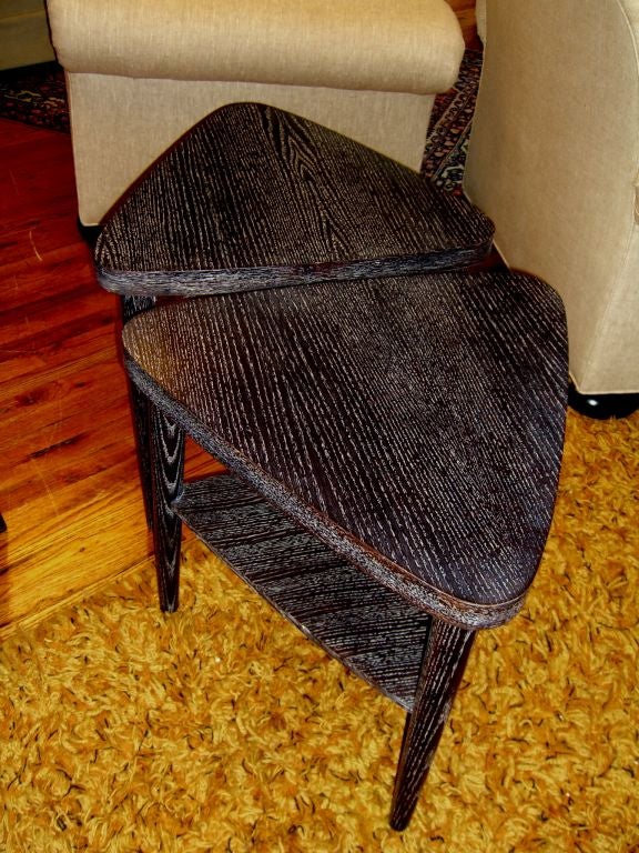 A nice pair of Triangular end tables in the manner of James Mont, that have been completely restored. They are in excellent restored condition.