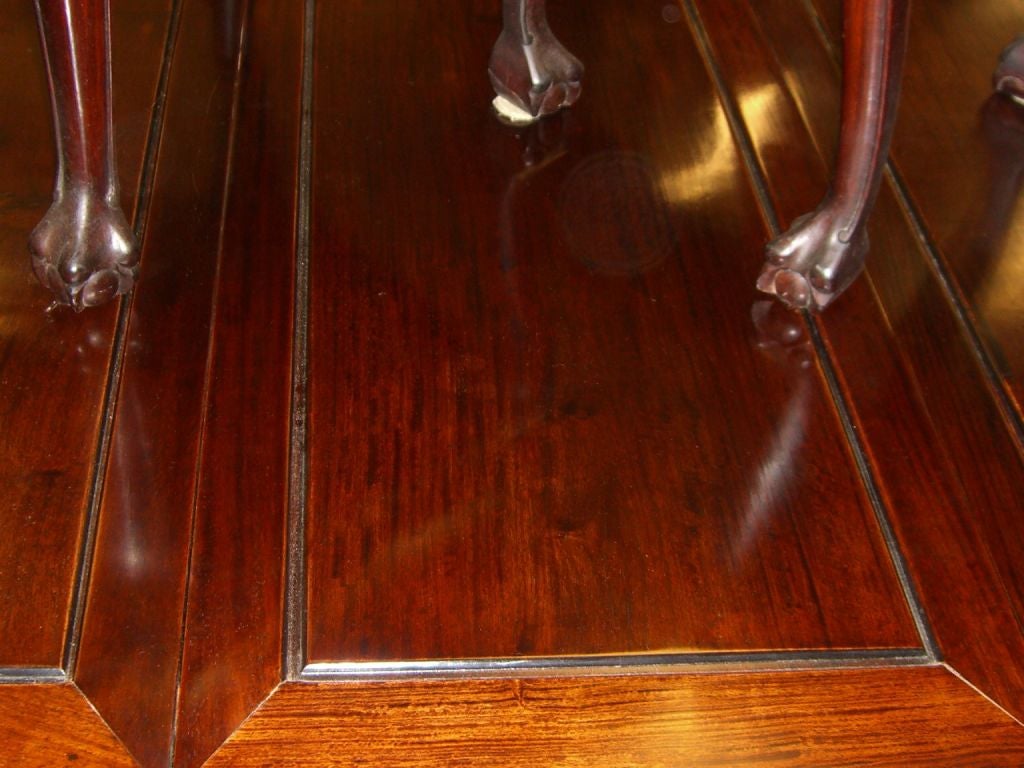 A nice Chinese hand carved dining room set made out of Huang Huali a type of Rosewood with beautiful graining. The table features crisp carving around the rim and has two leaves. The table as pictured has one leaf in and measures 78 inches long and