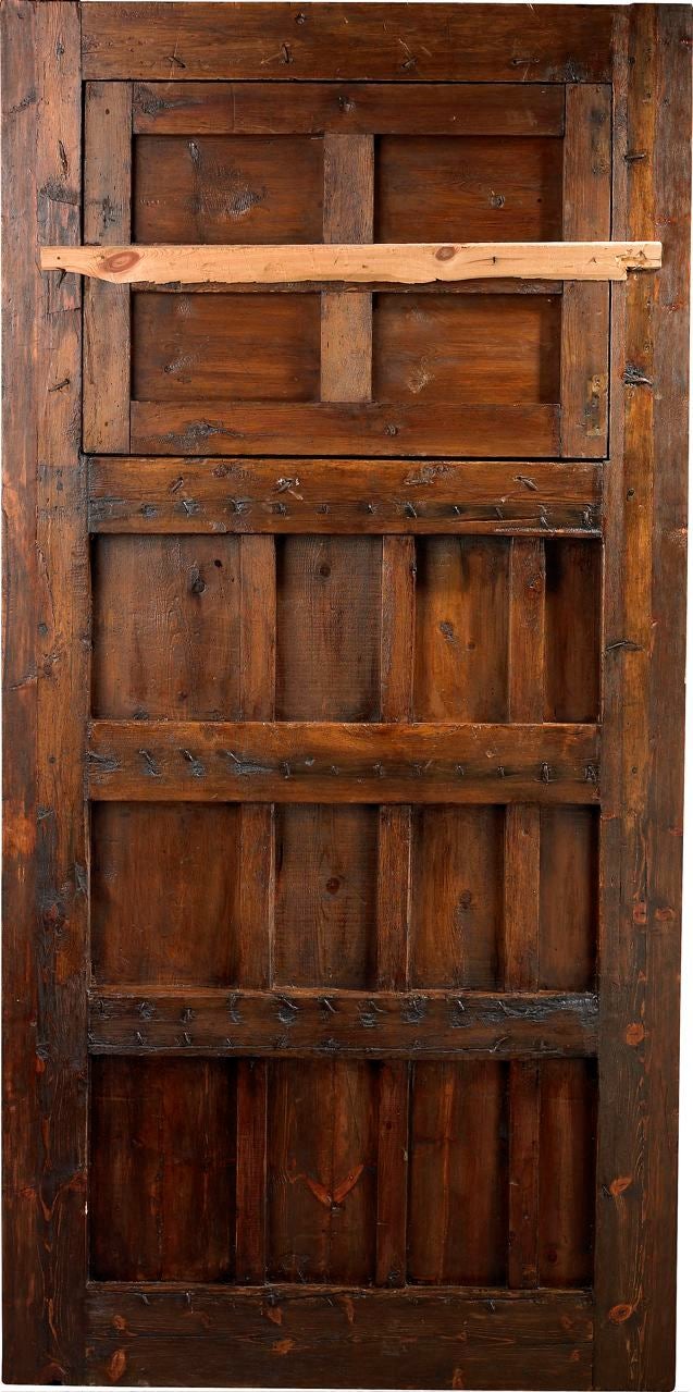 An 18th Century Spanish portal with antique clavos, window and wrought iron grille.  <br />
Reference # P 3278 www.porteradoors.com