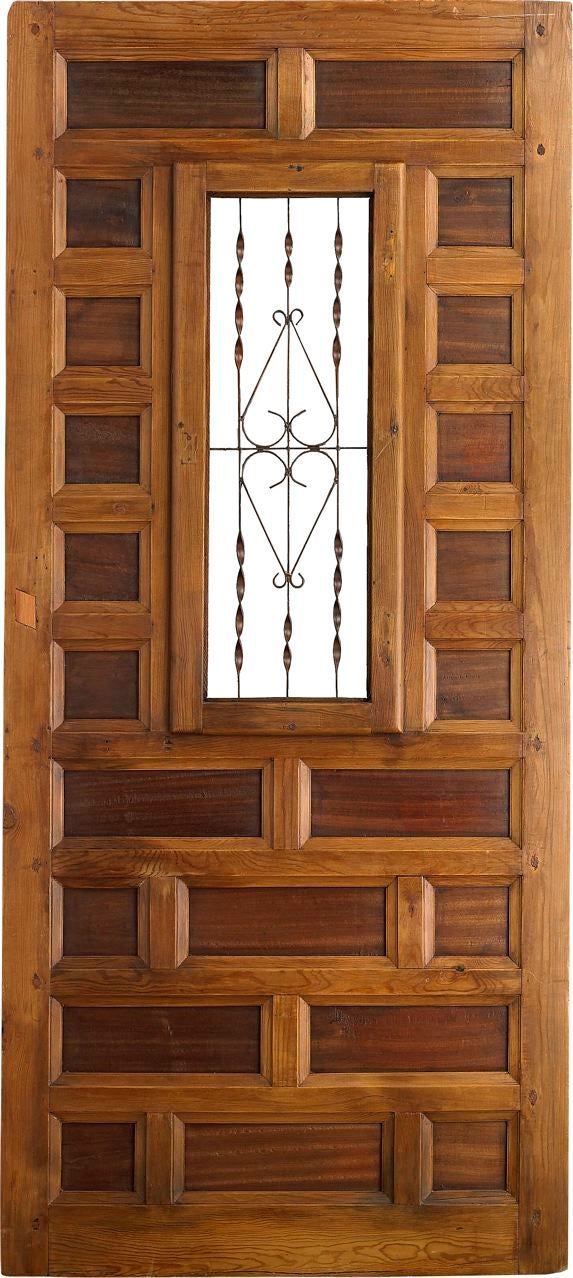 An antique Spanish door with carved panels, window and wrought iron grille, circa 1800's.<br />
Reference # P 2863 www.porteradoors.com