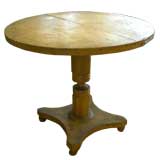 19th century tilt top table in old ochre paint.