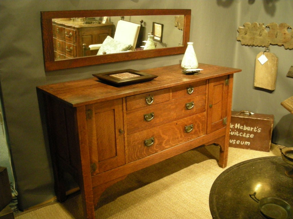 Stickley Brothers 'Quaint Furniture Company' sideboard in oak with original hardware and surface, together with conforming rectangular mirror. American c. 1915.  Signed with branded mark and Quaint Furniture Company paper label.