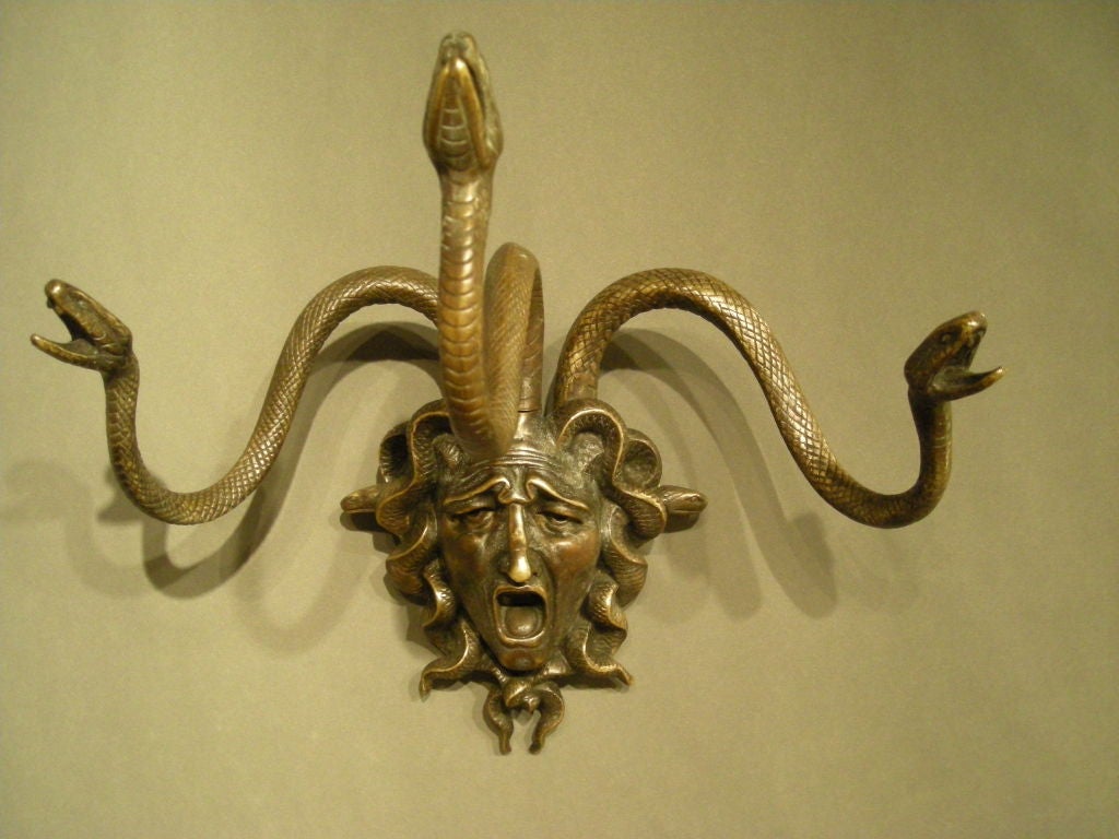 Pair of neoclassical style bronze Medusa wall decorations.