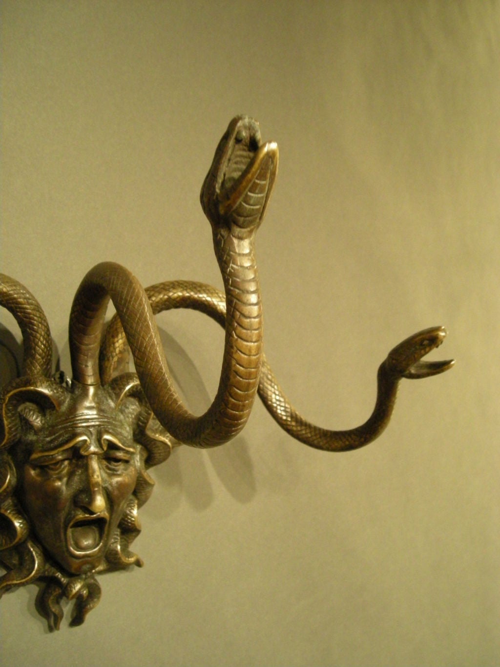 20th Century Pair of bronze Medusa wall decorations.