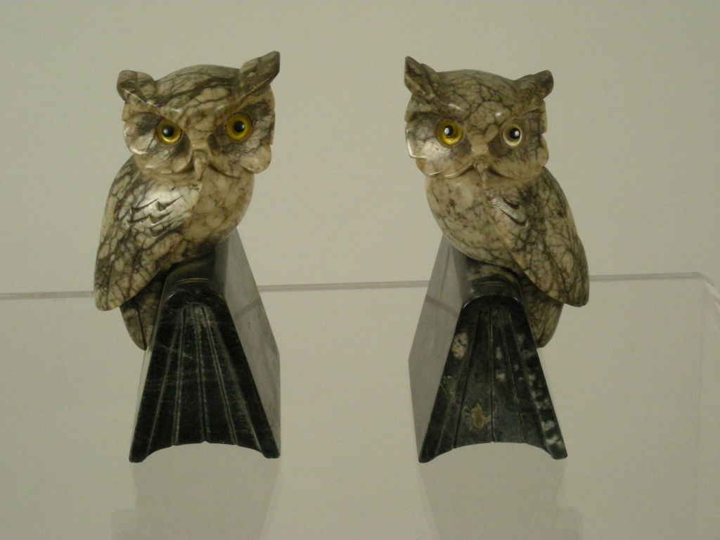 Pair of carved Italian marble bookends of owls, with yellow glass eyes, perched on open books.