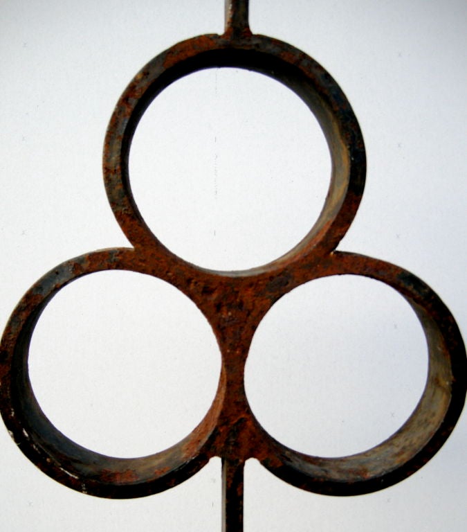 Sculptural and clean-lined iron architectural fragment on contemporary stand.