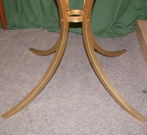 A gueridon table by Robert Thibier on a four section C base with ring center and top ring glass plateau support, all in gold leaf wrought iron. Base H73cm, Diam98cm.
