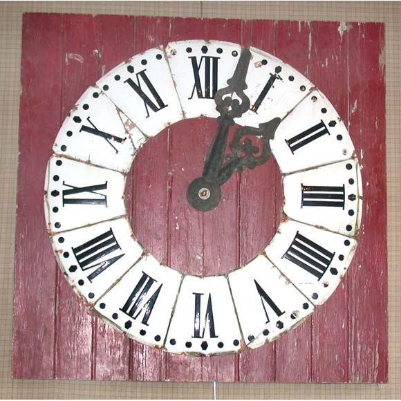 A late 19th century oxblood red painted square panel with enameled copper clock Roman digits and two arms, probably from a train station.