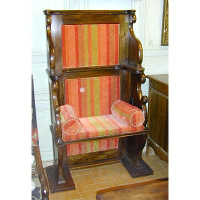 A pair of Cathedra Benches, pieces in carved wood and brightly colored re-upholstered cushions.