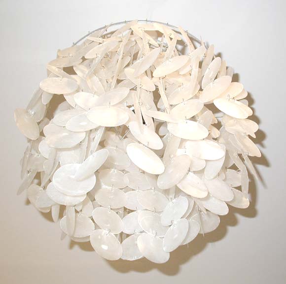 A ceiling light by Verner Panton with a metal tiered frame, one interior light and a mother of pearl linked disk shade.