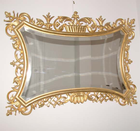 An ornate gold leaf open carved wood frame by Lajos Kosma with a central beveled edged mirror, carton back. Documentation available.