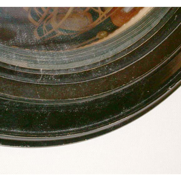 A Napoleon III oval convex mirror with ebony stained pear wood frame.