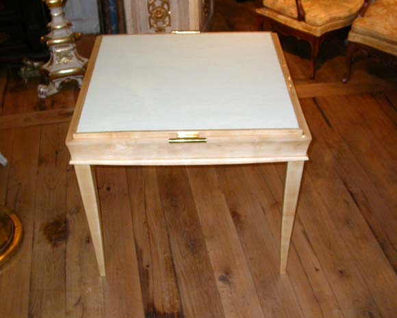 A game table by Dominique in sycamore with a gilt bronze handle reversible plateau with ivory felt reversed game top.