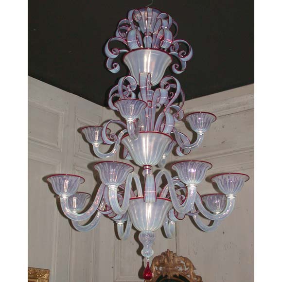 A three tier 12 branch Murano chandelier with ruby bordered opalescent glass and ruby glass finial, wired.
