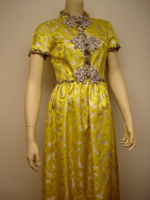 1960s silver lame brocade Princess cut evening gown with cutout detail. [Shoulder to shoulder: 15