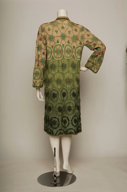 Mid-1920s extremely rare wool and rayon crochet 20s coat with metallic thread woven in. Concentric circle motif, three tone ombre green with beige on the bodice and sleeves.  Probably made in France.  Strong eastern European influence.