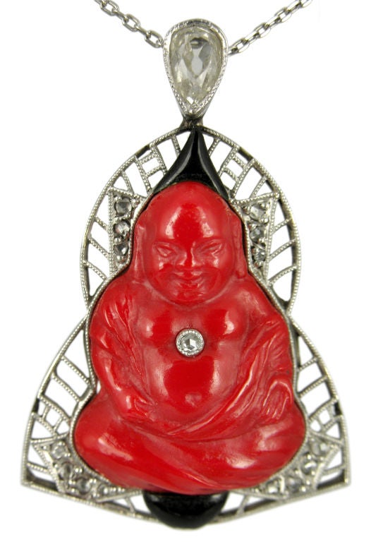 This Buddha is as happy as Buddhas get.  In bold red Peking glass, this platinum Art Deco piece is accented with black enamel and rose cut diamonds.  All that dropped from an Old Mine Cut pear diamond.