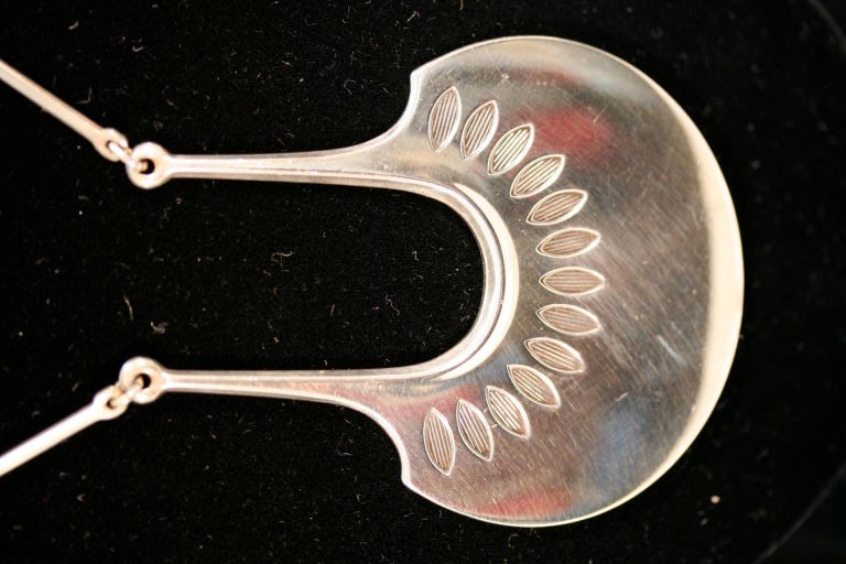 Classic Scandinavian design sterling silver necklace by David Andersen with an alternating elongated bar/ring chain and a decorative center pendant. Length of chain is 24 inches and the width of the pendant is 2 1/4 inches.