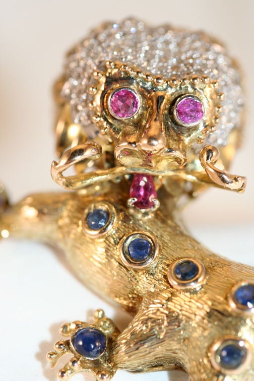Fantastic Stylized Foo Dog Brooch set in 18K gold with Diamonds, Rubies, and Sapphires.  Beautiful hand finishing to the gold.