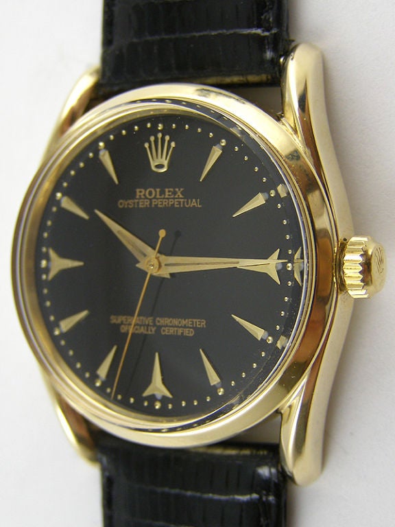 Rolex 14K YG Bombe ref # 6509 34mm diameter Oyster case  circa 1958. Beautifully restored glossy black dial with gold applied shark's teeth markers and pointy dauphine hands. Calibre 1030 self winding chronometer rated movement with sweep seconds.