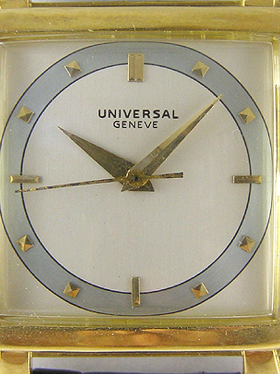 Universal Geneve 18K YG large stylized case with heavy bezel and fancy lugs. Beautiful 2 tone satin dial with gold applied indexes. Gold alpha hands sweep seconds. 17 jewel manual wind, circa 1950's. Includes original retailer's parchment