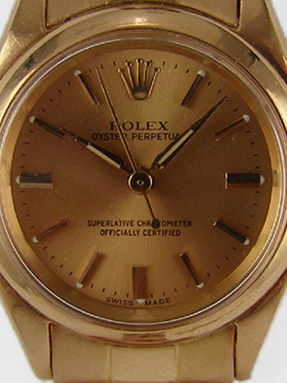 Rolex lady's 18K PG Oyster Perpetual ref# 6919 circa 1962. 27mm diameter Oyster case, antique salmon dial with pink applied indexes with pointy dauphine hands. Self winding calibre 1130 movement with sweep seconds. With original 18K PG Oyster