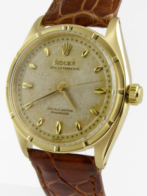Rolex 18K YG Oyster Perpetual ref 6569 circa 1956. Unusual model 34mm diameter Oyster case with fine engine turned bezel with hour indexes, richly patina'd original dial with large applied marquise shaped gold indexes and raised gold pearl minute