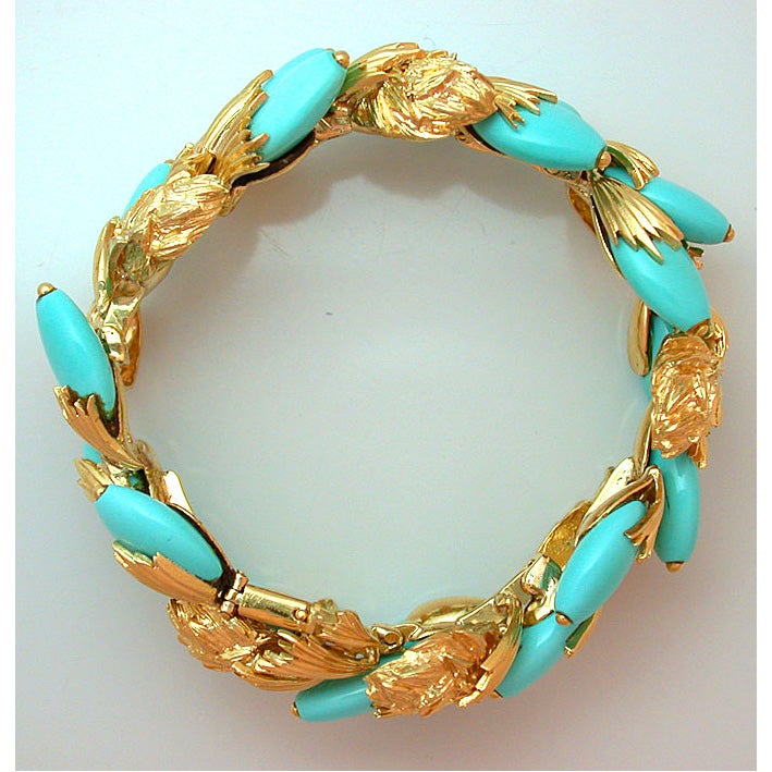 The early, tailored David Webb bracelet designed as a continuous branch of thistle, set randomly with oblong Persian turquoise beads on pegs, with a lovely mix of polished and textured gold elements, accompanied by matching earclips, signed Webb for