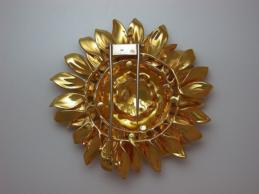 Realistically designed as a sunflower in bloom, the large brooch mounted in 18kt yellow gold, signed Asprey in script and stamped A PLC, with French assay mark for 18kt gold and French maker's mark, retailed through London, will full English