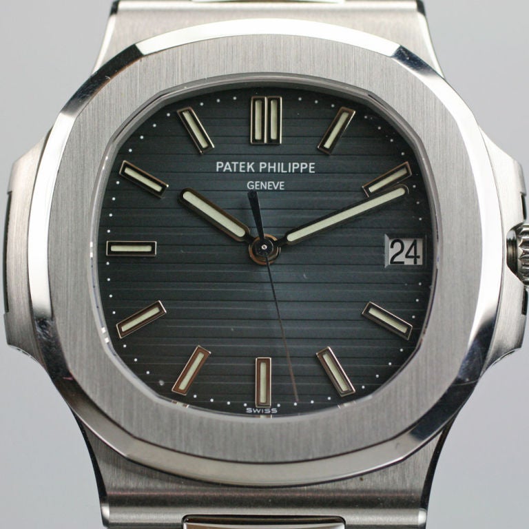 This is a mint condition reference 5711 Nautilus by Patek Philippe. This newer version of Patek's classic Nautilus features a sapphire exhibition back and come with the Patek Philippe certificate, booklets,lacquered wooden box,and outer box. 2008