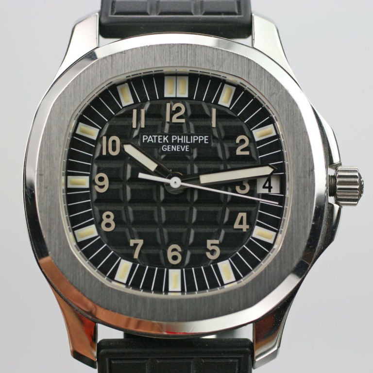 The Patek Philippe Aquanaut, reference 5065A, is a stainless steel Patek sport watch with a unique grid like black dial and sapphire crystal and exhibition back. The watch comes on the black rubber Tropical strap. The automatic Aquanaut is water